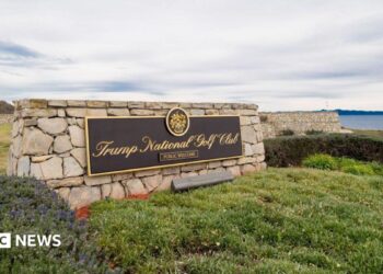 A sign for Trump's golf course overlooks a bluff in California