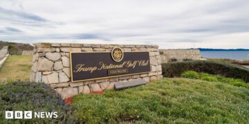 A sign for Trump's golf course overlooks a bluff in California