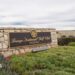 A sign for Trump's golf course overlooks a bluff in California