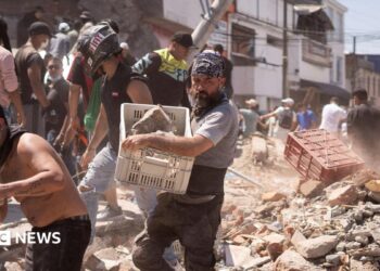Residents dig through the debris of a collapsed building after an earthquake, in Cali, Colombia