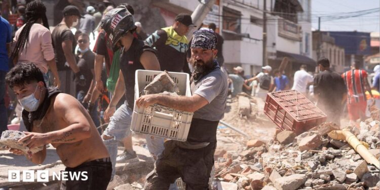 Residents dig through the debris of a collapsed building after an earthquake, in Cali, Colombia