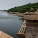 The Kariba dam seen from one of its ridges, overlooking the reservoir and green landscape in the distance