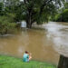 Chace Dexter films the swollen White River due to flooding after days of heavy rain in Noblesville