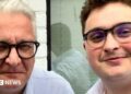 A close-up of two men both wearing glasses
