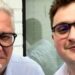 A close-up of two men both wearing glasses
