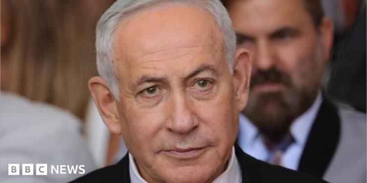 Close up of Benjamin Netanyahu from the shoulders up. He has short, grey hair and is wearing a shirt, tie and suit.