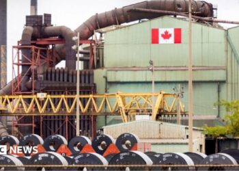A Canadian flag visible on the ArcelorMittal Dofasco steel plant in Hamilton.