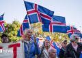 Supporters of the 'No' campaign wave Icelandic flags during a rally against reopening Iceland's European Union accession negotiations in Reykjavik, Iceland, on August 27, 2026