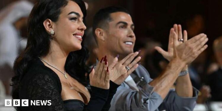 Ronaldo and his partner clap and smile in Dubai in 2014