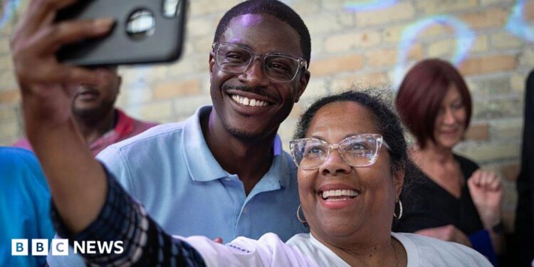 David Crowley poses for a selfie alongside a supporter while campaigning to be the Democratic candidate for Wisconsin governor