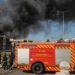Firefighters work at the site of a Russian drone strike as smoke rises, amid Russia's attack on Ukraine, in Kyiv region, Ukraine
