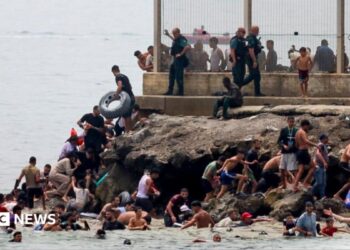 migrants swimming into Ceuta