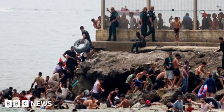 migrants swimming into Ceuta