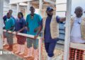 A row of men and women in medical uniforms and white wellington boots at the inauguration of a new Ebola treatment centre in Rwakole, Bunia, DR Congo.