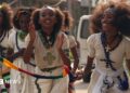 Orthodox Christian women clap as they walk down in traditional white outfits with silver cross necklaces in Mekelle in Ethiopia - archive shot