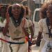 Orthodox Christian women clap as they walk down in traditional white outfits with silver cross necklaces in Mekelle in Ethiopia - archive shot