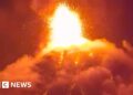 Orange lava erupts into the night sky