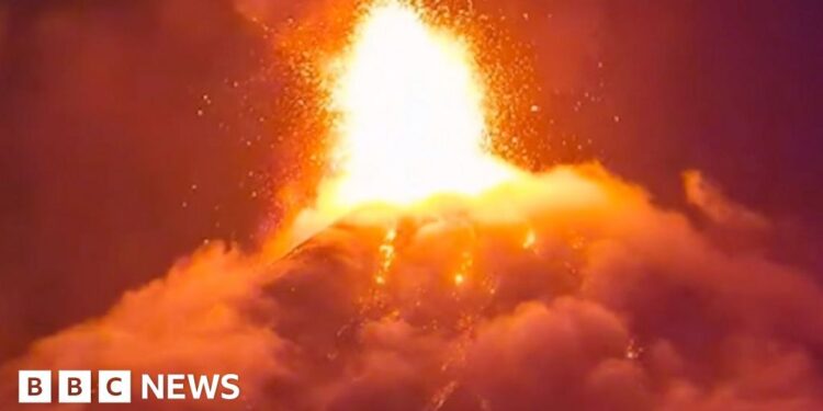 Orange lava erupts into the night sky