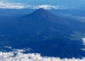 Mount Fuji is pictured from the skies with a ring of white cloud bordering the frame of the image