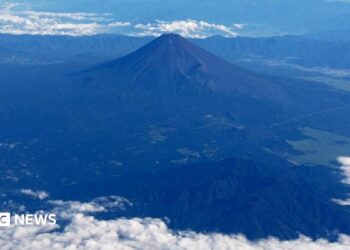 Mount Fuji is pictured from the skies with a ring of white cloud bordering the frame of the image