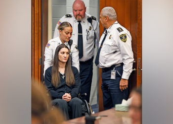 Massachusetts mother accused of killing her three children sits in a wheelchair during court appearance