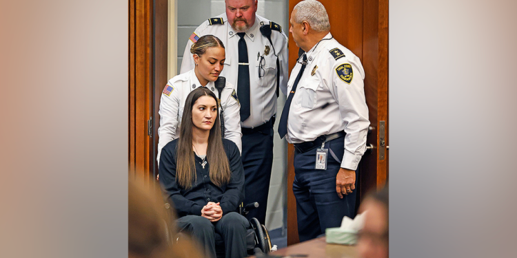 Massachusetts mother accused of killing her three children sits in a wheelchair during court appearance