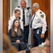 Massachusetts mother accused of killing her three children sits in a wheelchair during court appearance