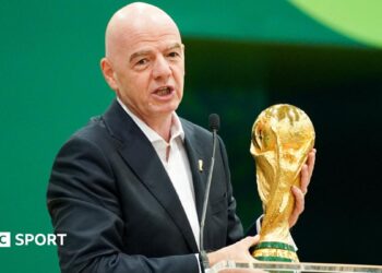 Gianni Infantino with the World Cup trophy at a pre-tournament news conference