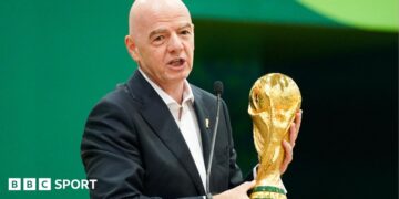 Gianni Infantino with the World Cup trophy at a pre-tournament news conference