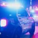 A file photo of a police car with flashing lights on a dark street