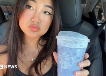 Elaine Ling holds a lavender Grande Ocean Drink from Starbucks