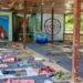 Mats and rugs can be seen on the floor of an open-walled space for meditation