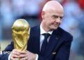 Gianni Infantino with his hands around the men's World Cup trophy