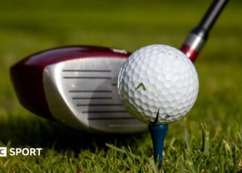 Picture showing golf driver next to a golf ball on a tee