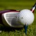 Picture showing golf driver next to a golf ball on a tee