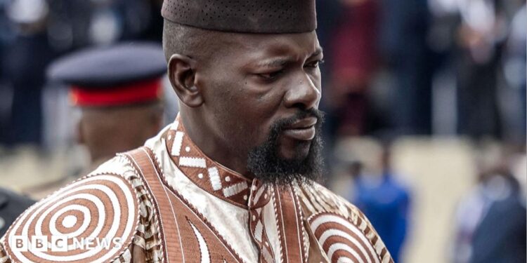 Guinea's President Mamady Doumbouya in a brown and white embroidered outfit in May 2026