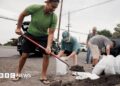 Captain Hook, Hawaii residents prepare stuff bags with sand in preparation of Tropical Storm Lala on Friday