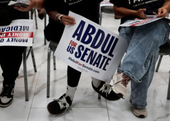 Supporters of U.S. Senate Democratic candidate Abdul El-Sayed hold campaign signs during a rally in Dearborn
