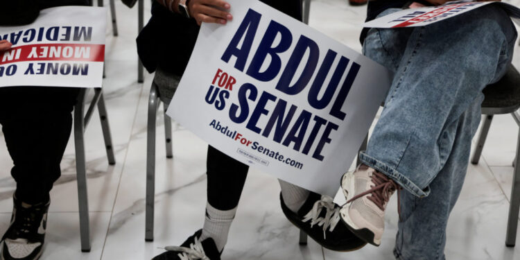 Supporters of U.S. Senate Democratic candidate Abdul El-Sayed hold campaign signs during a rally in Dearborn