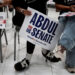Supporters of U.S. Senate Democratic candidate Abdul El-Sayed hold campaign signs during a rally in Dearborn