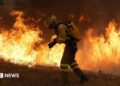 A firefighter battles a large blaze