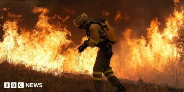 A firefighter battles a large blaze