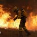 A firefighter battles a large blaze