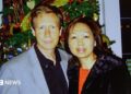 A police handout of Peter Chadwick and his wife Quee Choo Chadwick. They are shoulder to shoulder and looking at the camera, stood in front of a Christmas tree. He is in a grey suit jacket and black shirt, she is wearing a red top and black jacket.