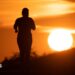 A woman jogs along a path as the sun rises in Frankfurt am Main, Germany, 09 July 2026.