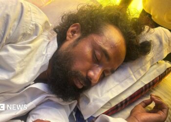 Devendra Nath Mahto lying on a mattress while he was on a hunger strike