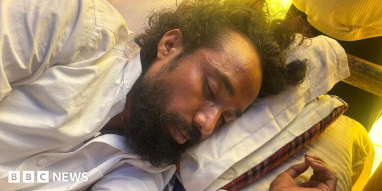 Devendra Nath Mahto lying on a mattress while he was on a hunger strike