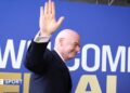 Fifa president Gianni Infantino waves while walking