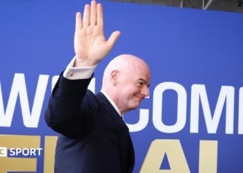 Fifa president Gianni Infantino waves while walking