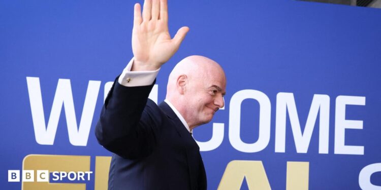 Fifa president Gianni Infantino waves while walking